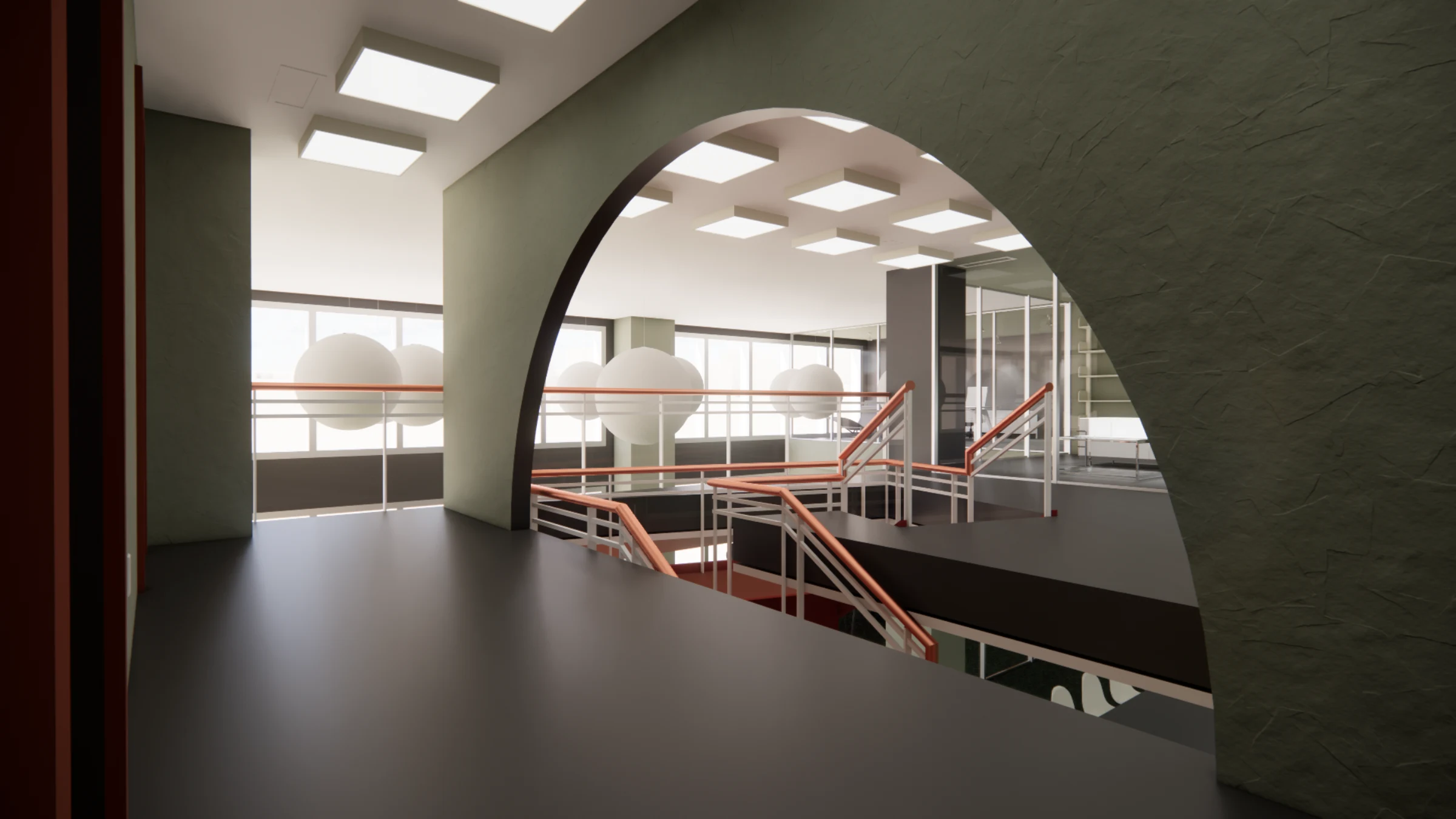 View of the mezzanine through an arched opening, with raw stucco walls and a balcony overlooking the workspace below