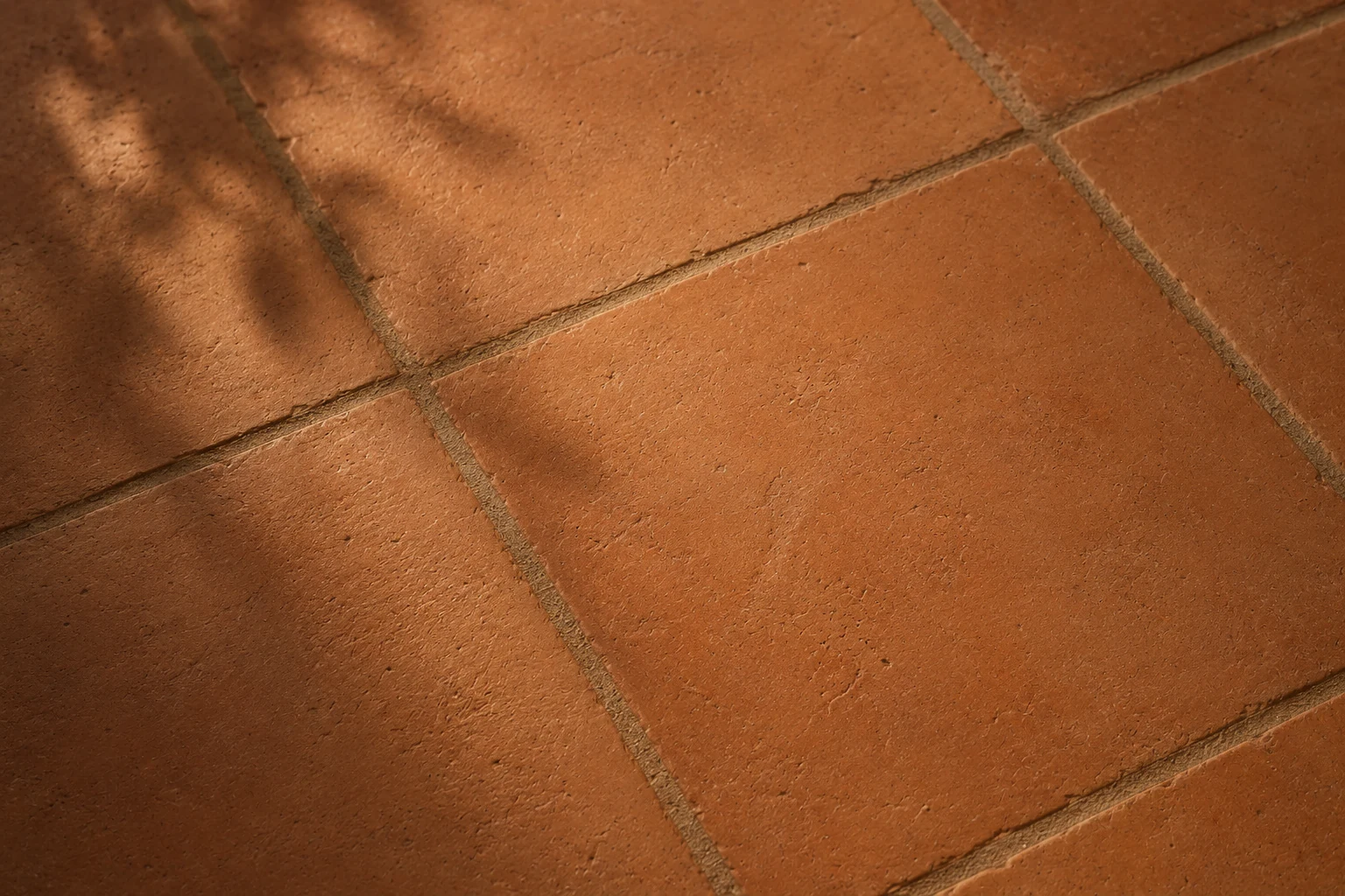 Handmade terracotta tile in warm afternoon light